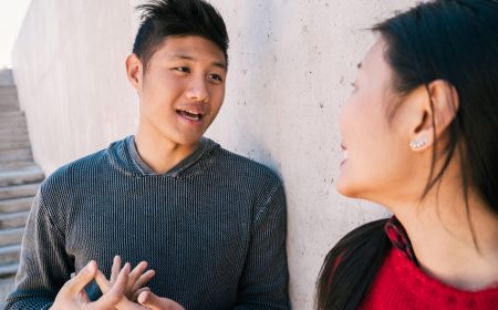Portrait of lovely Asian couple having a conversation while looking at each other.