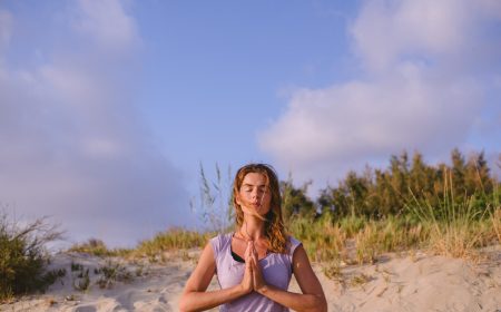woman-meditating-on-the-beach-PSN59HP